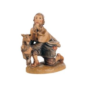 Shepherd kneeling with kid