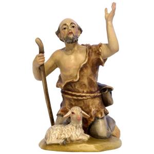 Pastore inginocchiato con pecora