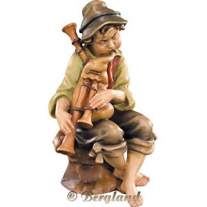 Pastore seduto con zampogna